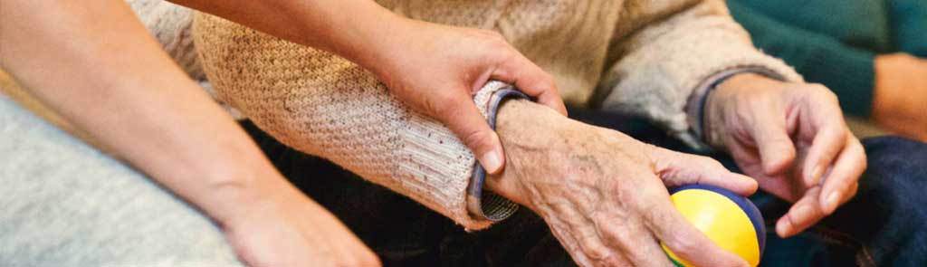 A physical therapist holding a patient's arm