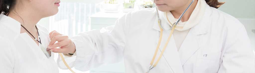 Doctor listening to patient's heart